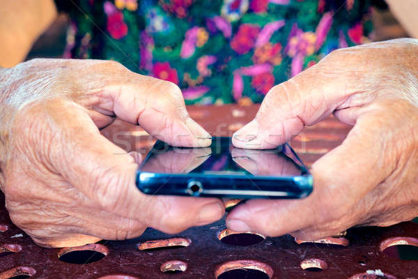 Hands on cell phone Stock photo © badmanproduction