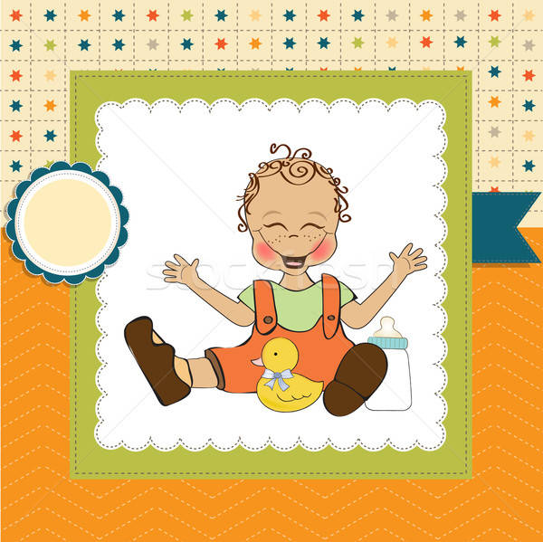 baby boy playing with his duck toy, welcome baby card Stock photo © balasoiu