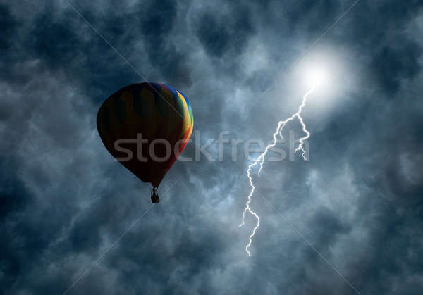 Hot-Air Balloon Among Dark Storm Clouds with Lightning Stock photo © Balefire9