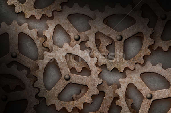 Distressed interlocking gears lit diagonally Stock photo © Balefire9