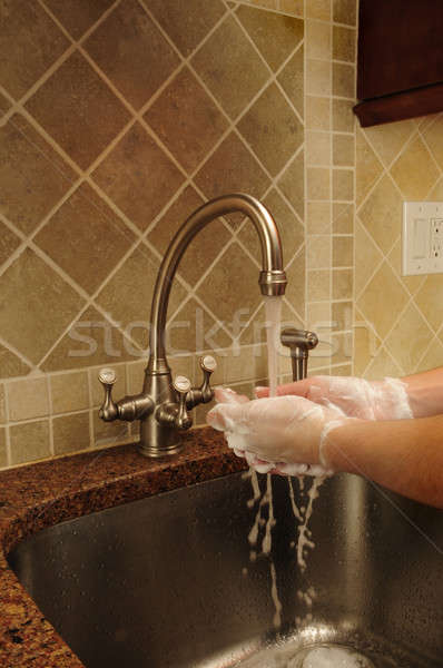 Hand washing and rinsing soapy water at a sink Stock photo © Balefire9