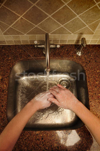 Overview of hand washing over a stainless steel sink Stock photo © Balefire9