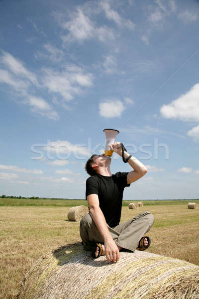 Stock photo: man on bale with loudspeaker