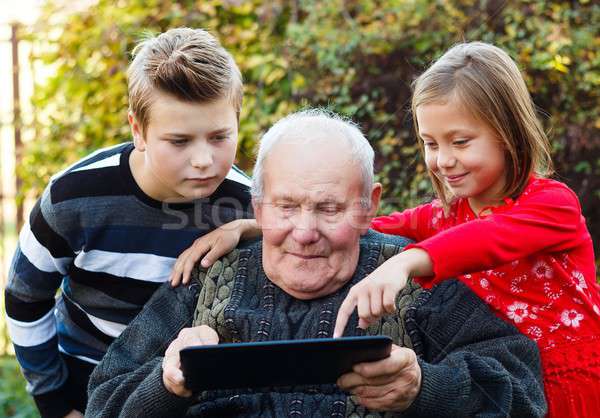 Grandfather learning something new Stock photo © barabasa