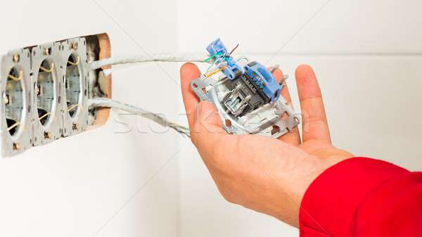 Electrician Mounting Electrical Wall Outlet Stock photo © barabasa