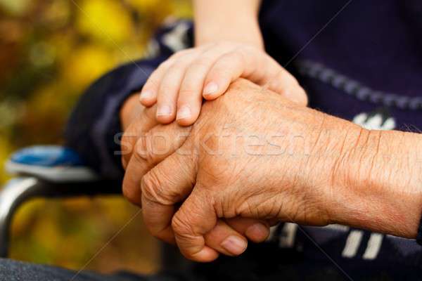 Tisztelet egyensúly fiatal kéz tart öreg Stock fotó © barabasa
