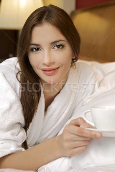 Closeup portrait of a happy young beautiful woman with a white c Stock photo © bartekwardziak