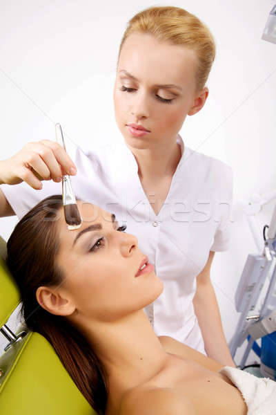 young woman getting beauty skin mask treatment on her face with  Stock photo © bartekwardziak