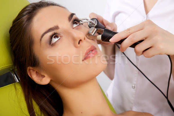 woman having a stimulating facial treatment from a therapist Stock photo © bartekwardziak