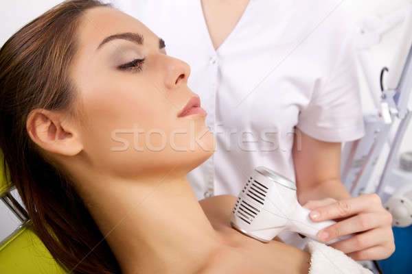 Stock photo: woman having a stimulating facial treatment from a therapist