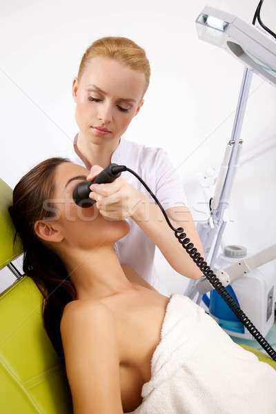 Young woman receiving laser therapy Stock photo © bartekwardziak