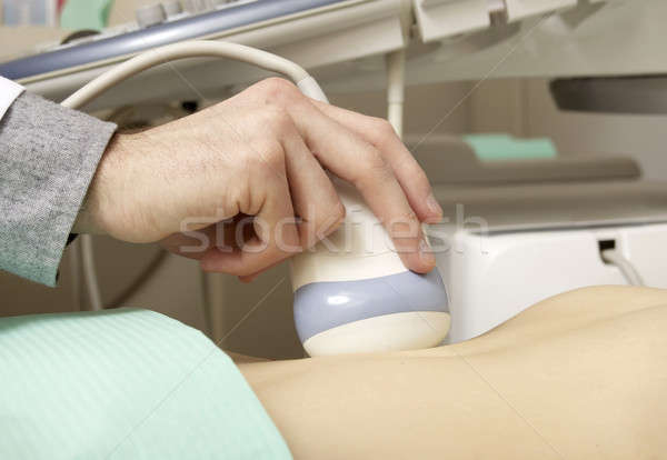 Pregnant woman getting ultrasound from doctor Stock photo © bartekwardziak