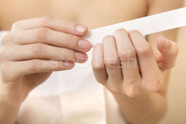 Woman polishing fingernails with the nail file Stock photo © bartekwardziak