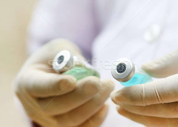 Two vials holding by a doctor Stock photo © bdspn