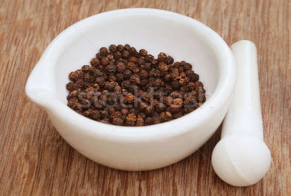 Black peppercorn on a mortar with pestle Stock photo © bdspn