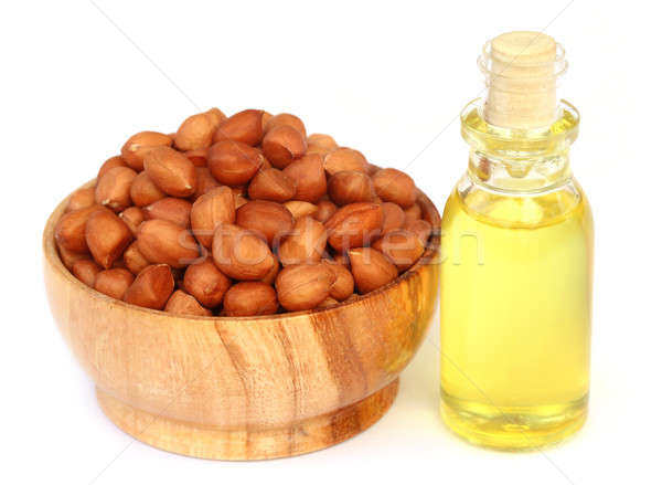 Peanut and oil over white background Stock photo © bdspn