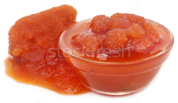 Molasses in a glass bowl over white background Stock photo © bdspn