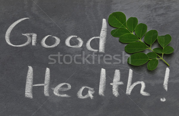 Moringa leaves with Good Health written in a slate Stock photo © bdspn