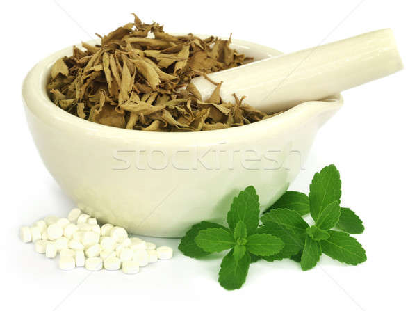 Dry and green stevia with pills Stock photo © bdspn