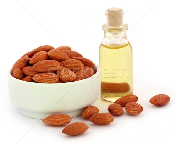 Fresh almonds with bottle of oil Stock photo © bdspn