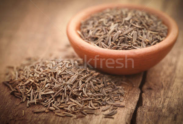 Kimyon tohumları çanak çömlek ahşap yüzey çanak Stok fotoğraf © bdspn