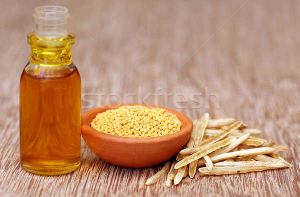 Golden Mustard with empty pods and oil in a bottle Stock photo © bdspn