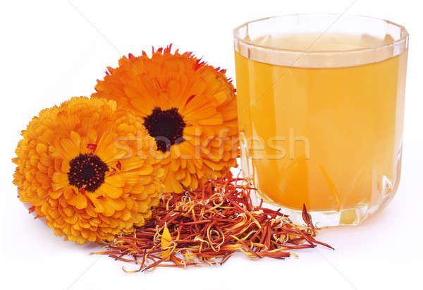 Stock photo: Herbal calendula flower with extract in a glass