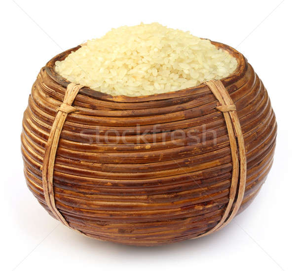 Uncooked rice in hand made busket  Stock photo © bdspn