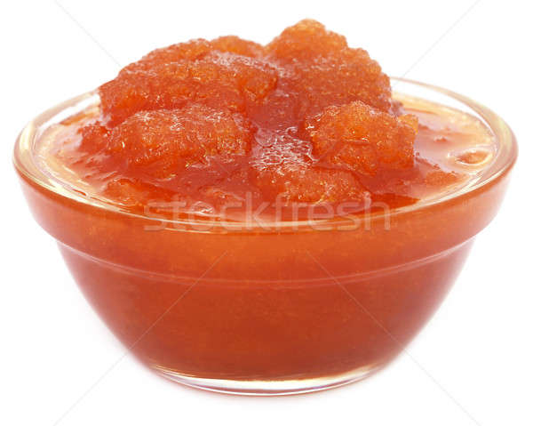 Molasses in a glass bowl over white background Stock photo © bdspn