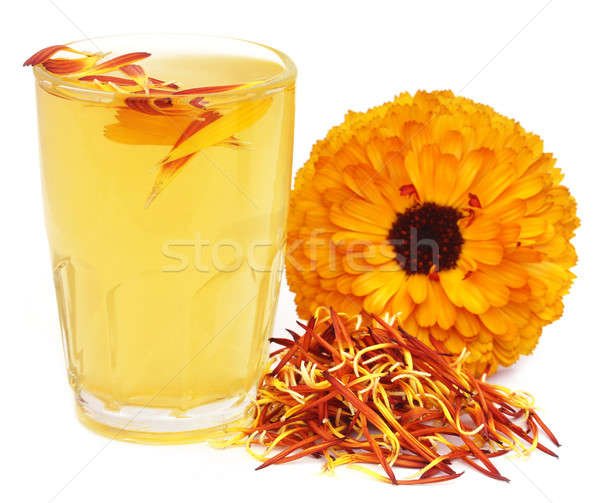 Stock photo: Herbal calendula flower with extract in a glass