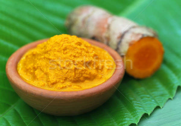 Mashed turmeric in a clay bowl Stock photo © bdspn