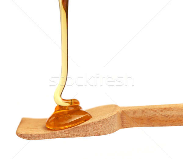 Stock photo: Dripping honey on wooden spoon