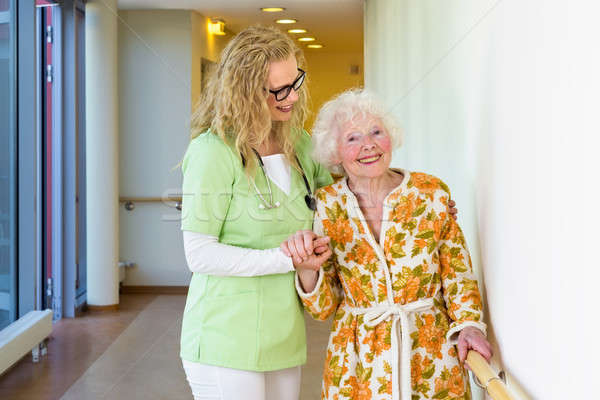 Medical Assistant Helping Happy Old Woman Walking Stock photo © belahoche