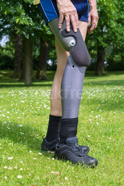 Side view on false leg of man walking on grass Stock photo © belahoche