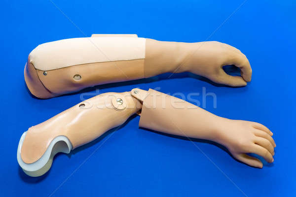 Pair of prosthetic arms over blue background Stock photo © belahoche