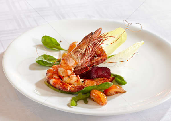 fried scampi with mixed salad leaves and cherry tomatoes Stock photo © belahoche