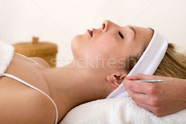 Homeopath applying auriculotherapy techniques. Stock photo © belahoche