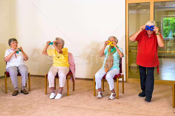 Four seniors having fun during exercise class Stock photo © belahoche