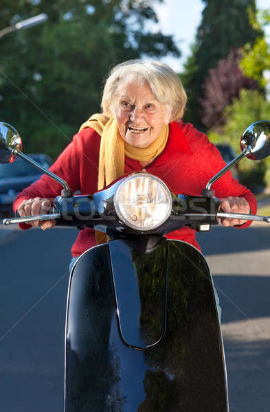 Idős nő száguld moped bicikli utca Stock fotó © belahoche