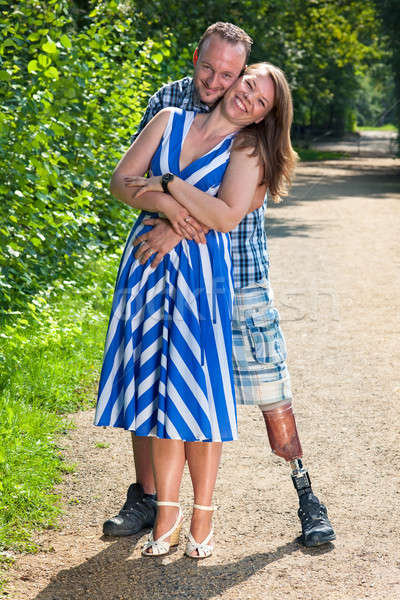 Disabled man and attractive woman in loving hug Stock photo © belahoche