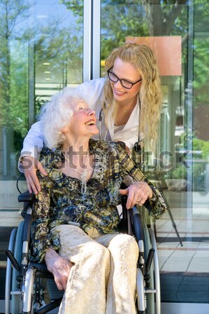 Happy Nurse and Elderly Patient Smiling at Camera Stock photo © belahoche