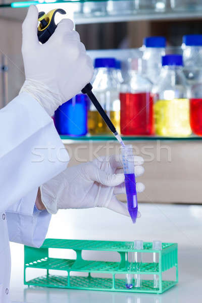 Hands of a lab technician using a pipette.  Stock photo © belahoche