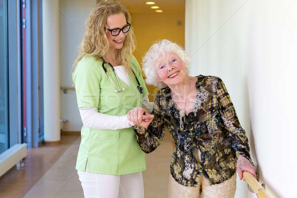 Medical Assistant Assisting Happy Elderly Patient Stock photo © belahoche