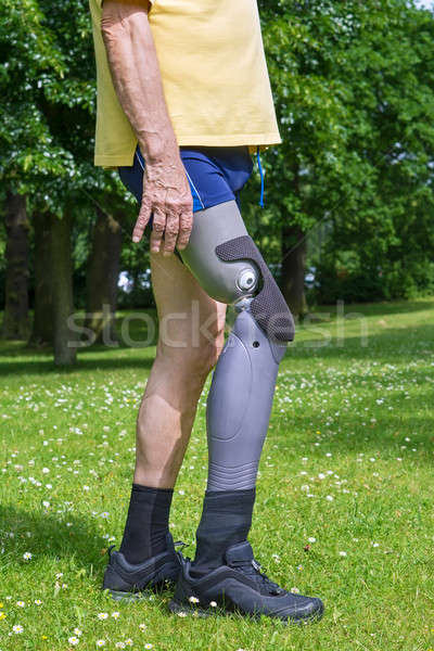 Close up on legs of man walking on grass Stock photo © belahoche