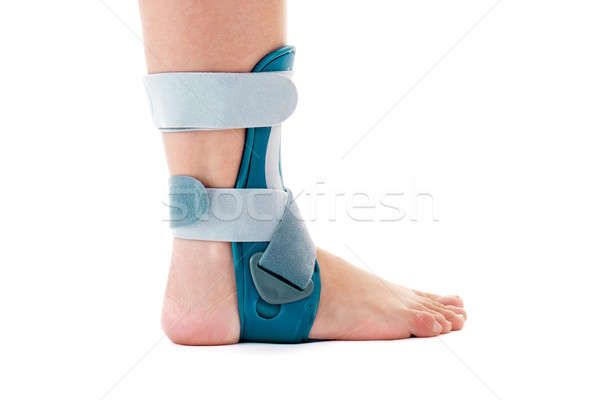 Stock photo: Man Wearing Ankle Support Brace in White Studio