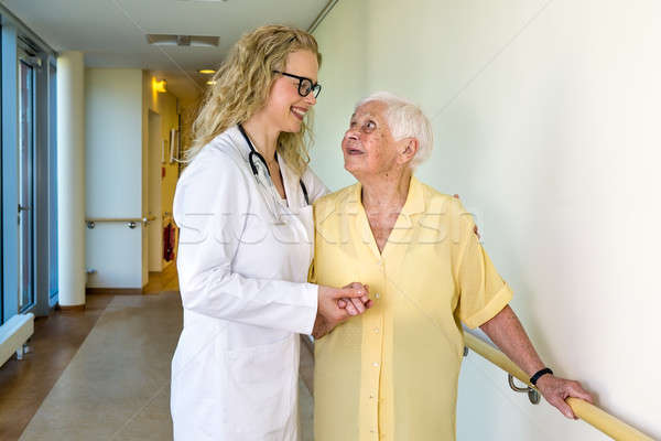 Medical Assistant Assisting Elderly in Hospital Stock photo © belahoche