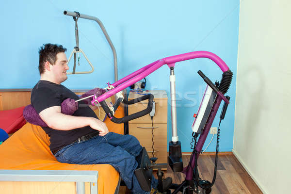 Stock photo: Patient with cerebral palsy using a patient lift