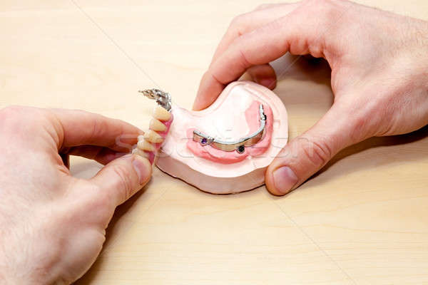 Artificial Facial Teeth on Wooden Table Stock photo © belahoche