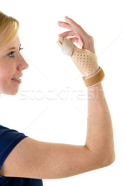 Smiling Blond Woman Wearing Supportive Thumb Brace Stock photo © belahoche
