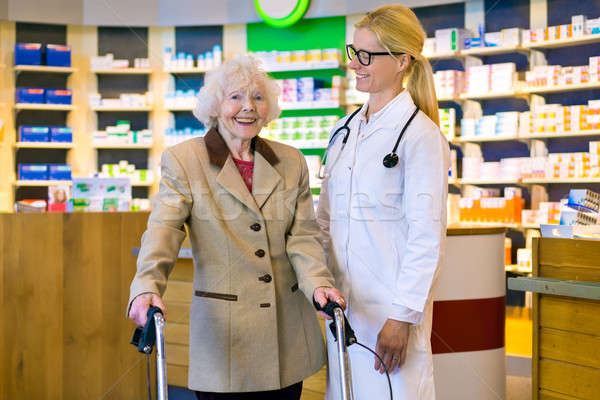 Senior patient happy with her smiling doctor Stock photo © belahoche